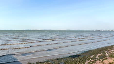 gentle waves roll onto sandy beach