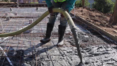 concrete is poured into foundation frame full of rebar and electrical