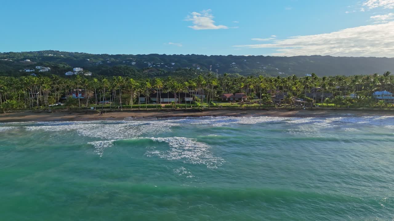 Lateral Flight Over Playa Bonita, Las Terrenas, Featuring Palm Trees and Luxury Villas