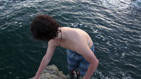 a man jumping off a cliff doing a double backflip