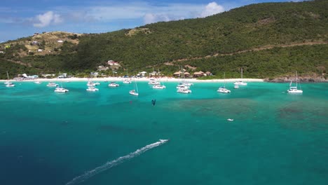 british virgin islands, aerial view of anchored boats by white sand beach and coastline of belle vue island