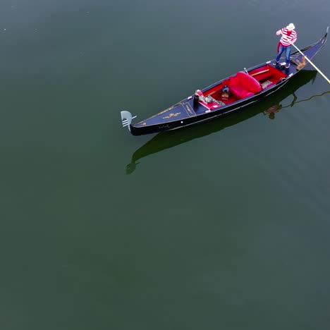 gondolier putting gondola through river
