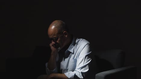 Depressed-Mature-Man-Struggling-With-Mental-Health-Sitting-In-Darkness-On-Sofa-With-Low-Key-Lighting-2