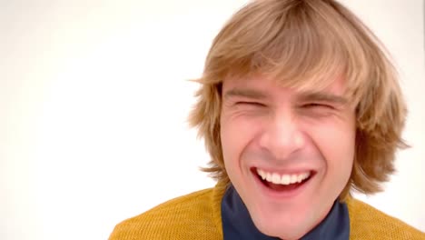 handsome hipster laughing on white background