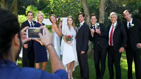 photographer taking photo of bride and groom with there family 4k 4k