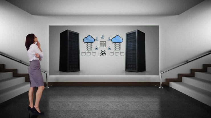 Business woman looking at server towers for cloud storage