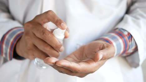 doctor applying hand sanitizer