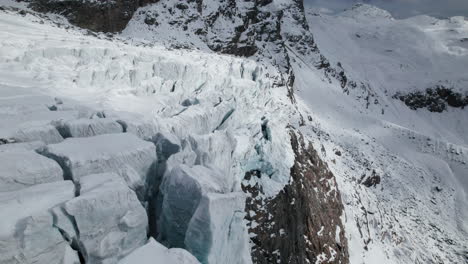 Drone-view-of-large-glacier-reflecting-off-sunny-day-in-winter-in-the-Alps