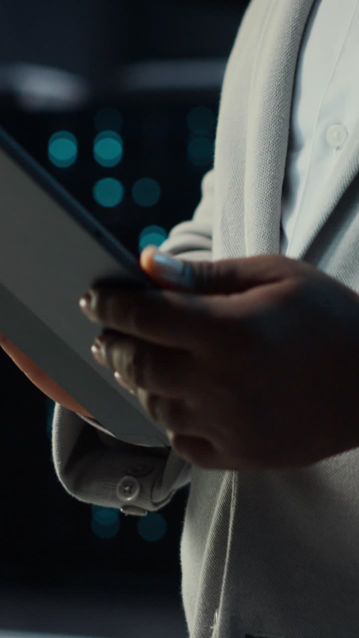 Vertical video IT professional in server hub ensures data remains shielded from threats