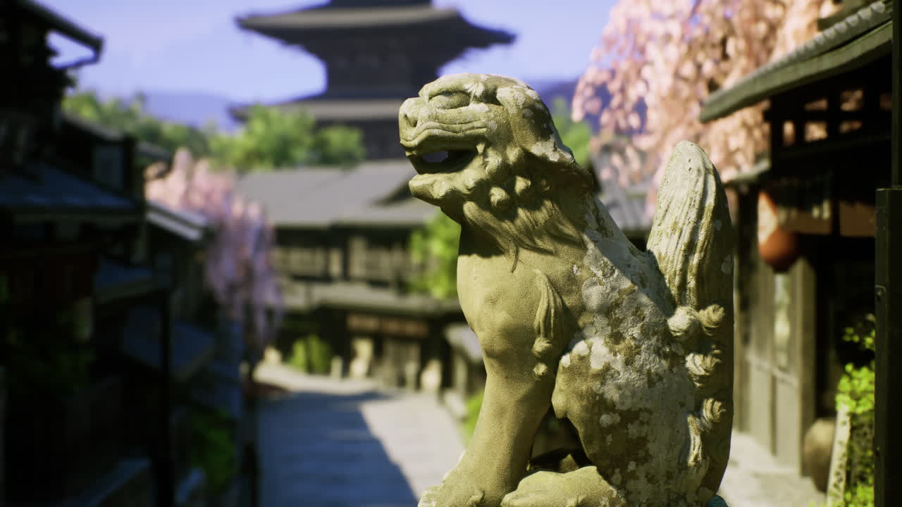 Ancient lion statue overlooking a quiet street lined with cherry blossoms