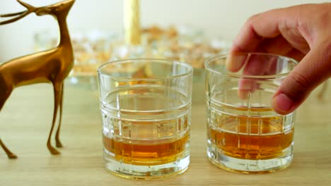 placing a glass of whiskey on a table