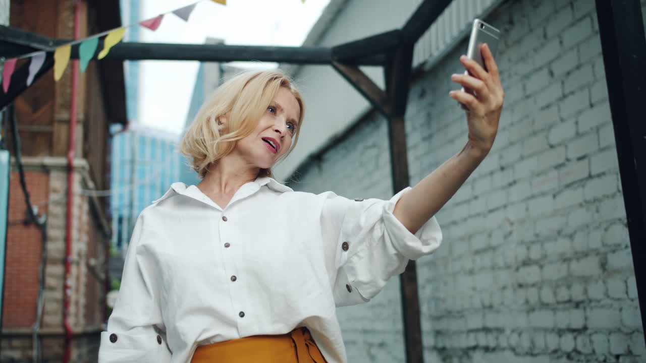 Woman Taking Selfie in Urban Alley