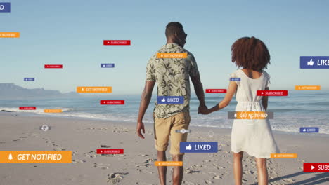 Animación-De-Notificaciones-De-Redes-Sociales-Sobre-Una-Pareja-Tomada-De-La-Mano-Y-Caminando-Por-La-Playa