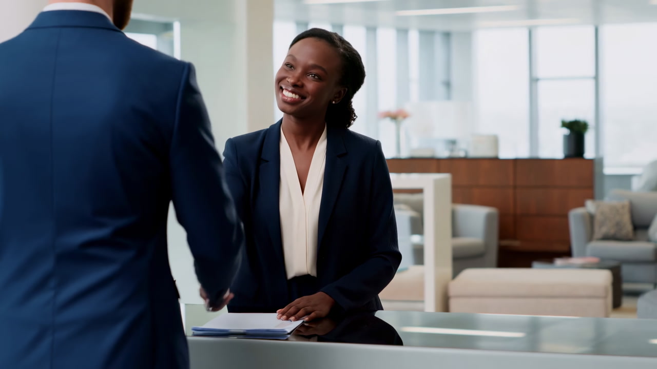 Black Receptionist Greeting Client At Desk, Human Resources Coordinator Offering Handshake And Friendly Smile