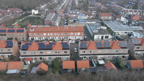 Aerial-dolly-of-suburban-neighborhood-with-solar-panels-on-rooftops