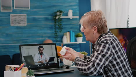 remote doctor using webcam prescribing medicine to sick aged woman