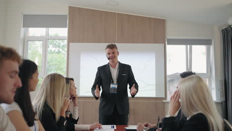 young business coach with headset is speaking and communicating with business people