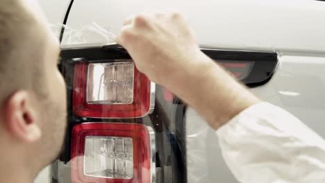 applying protective film to car tail light