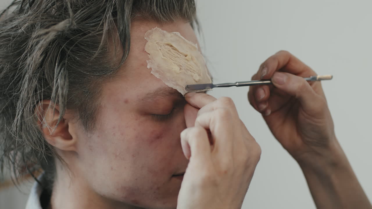 Putting SFX Makeup on Man