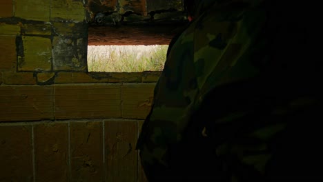 Volunteer-soldier-defends-his-country-in-a-fortified-bunker---checking-for-enemy-movement