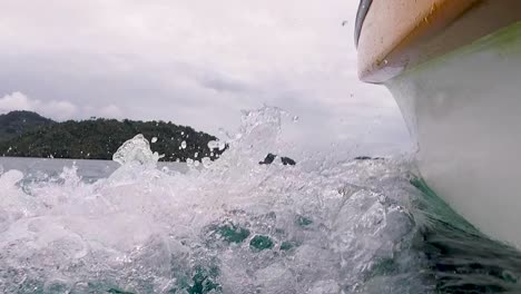 Whitewater,-waves-and-ocean-spray-from-bow-front-of-boat-on-a-journey-travelling-to-small-remote-tropical-island-in-Bougainville,-Papua-New-Guinea