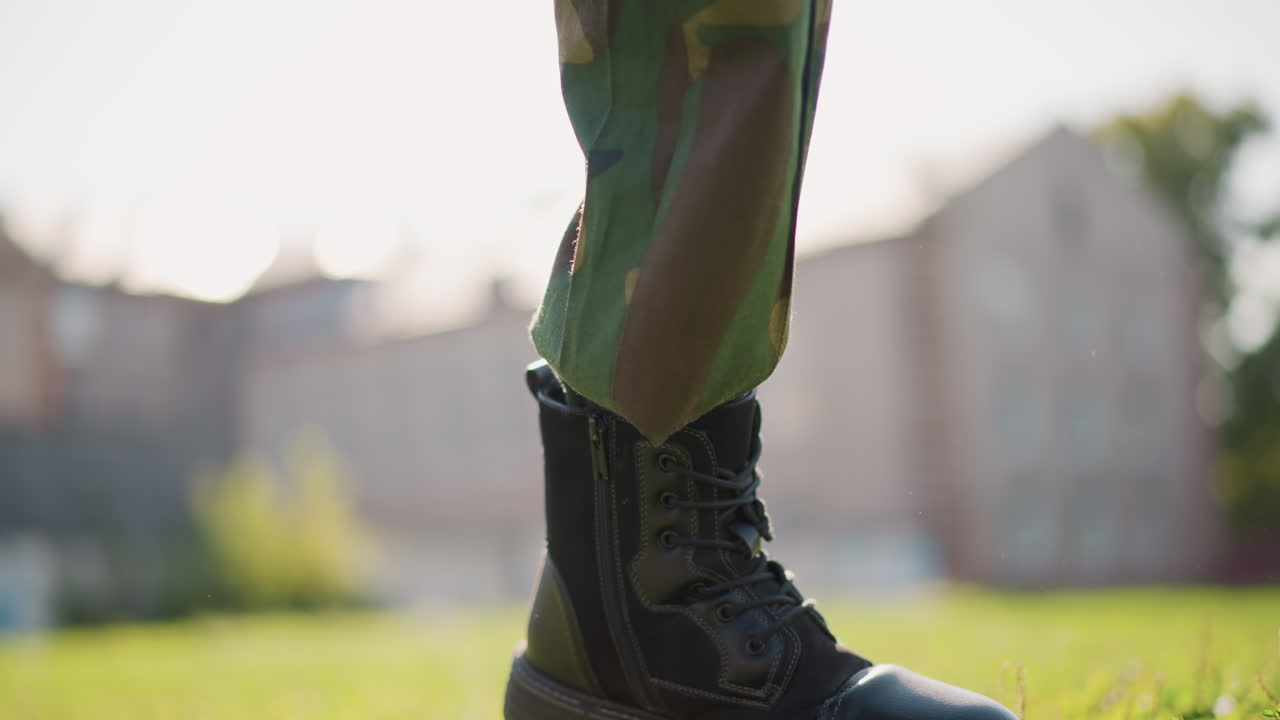 Athlete Recharges After Rigorous Practice, Person Pauses On Ground After Demanding Physical Training Session, Young Trainee Takes Break On Greenery Following Intense Exercise Routine And Sunlight