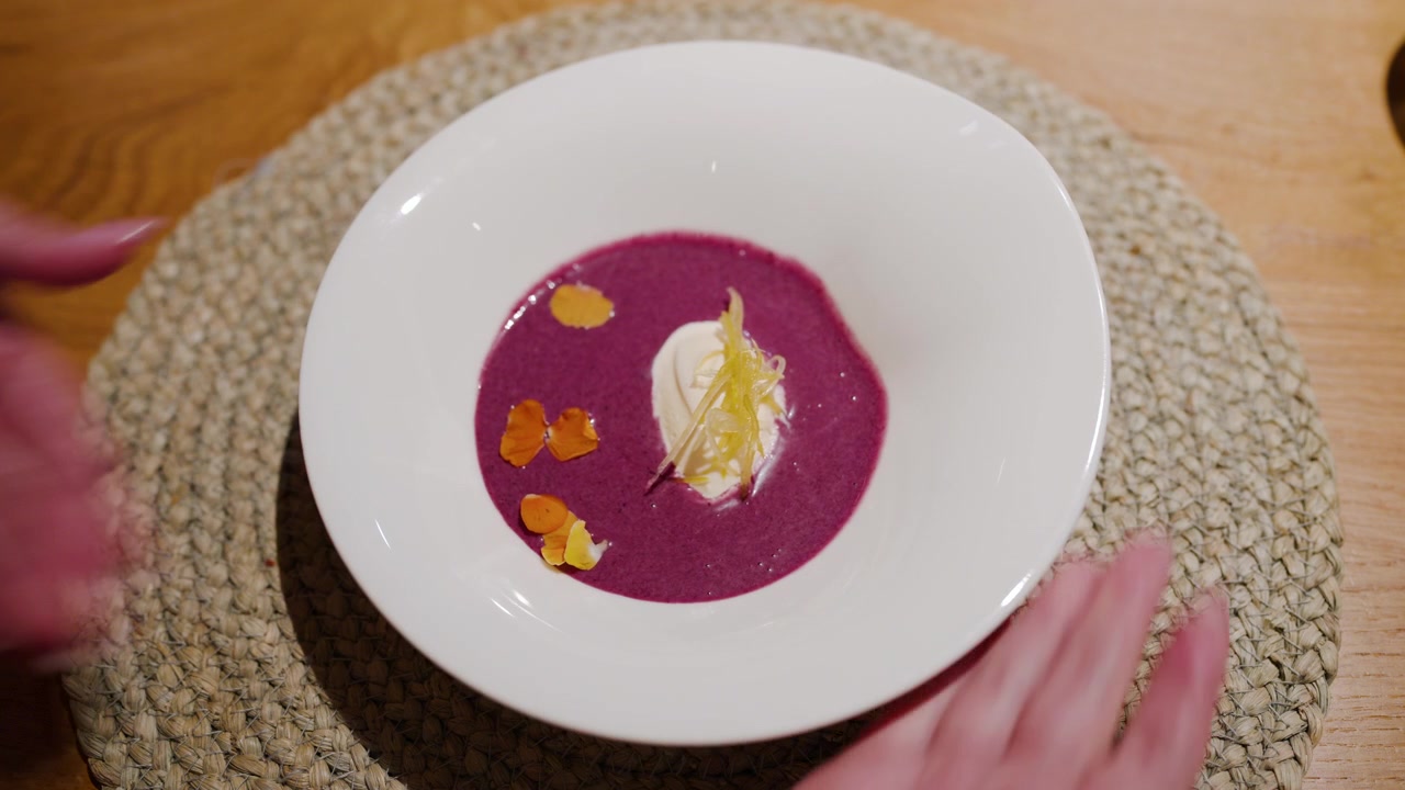 Brightly Coloured Red Cabbage Gazpacho Topped With A Simple Spoonful Of Horseradish Ice Cream. High-angle shot
