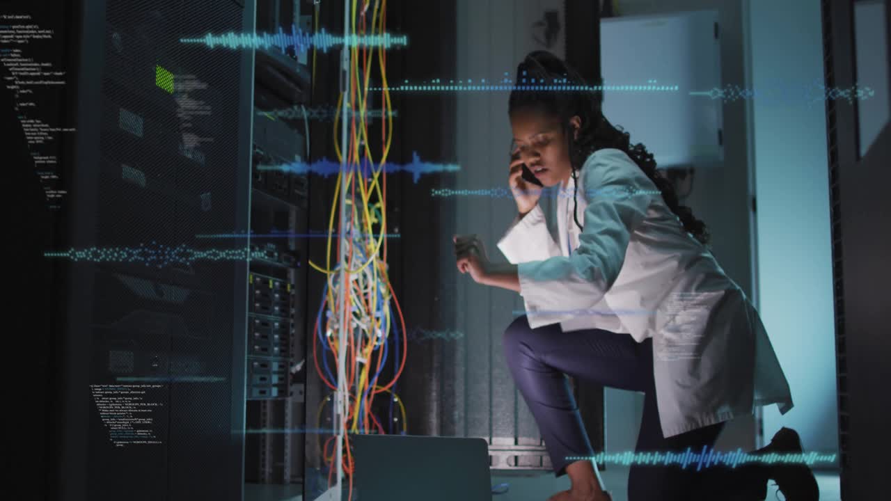 female IT technician kneeling beside server rack in data center, showing waveform graphics