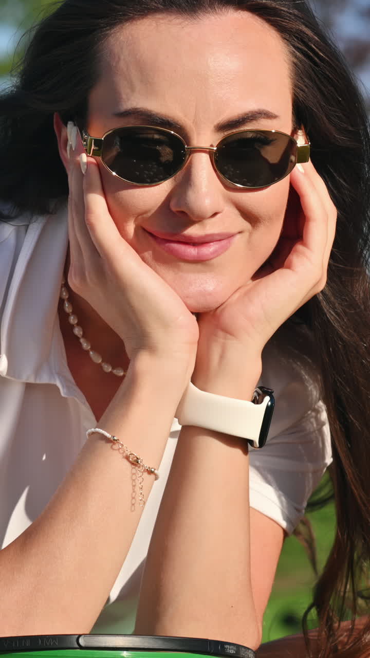 Woman in green skirt standing on the golf course near a bucket with balls. Vertical