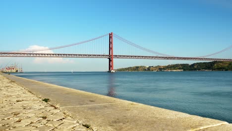 25 of april bridge over the tagus river in lisbon portugal on a clear bright sunny day near harbor entrance