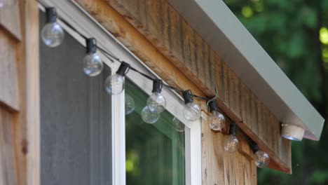 garland string light with transparent bulbs on the wooden cabin