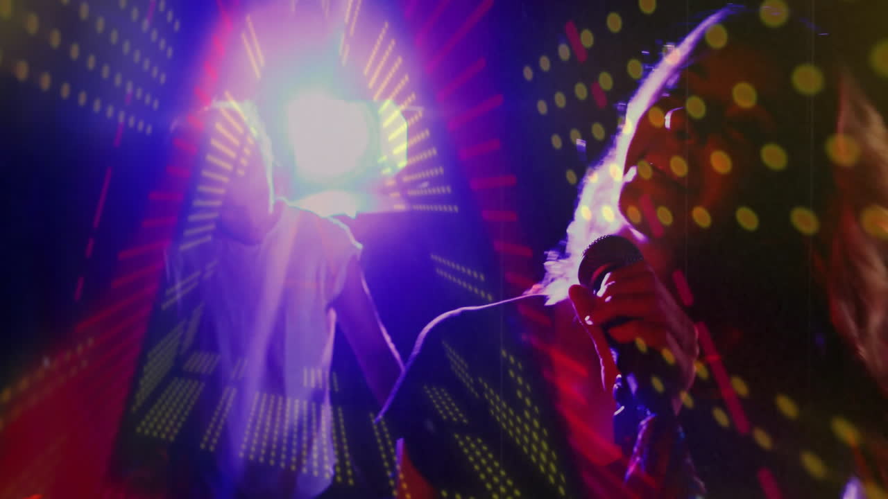 Male DJ mixing console, female singer holding microphone under laser LED projections in music show