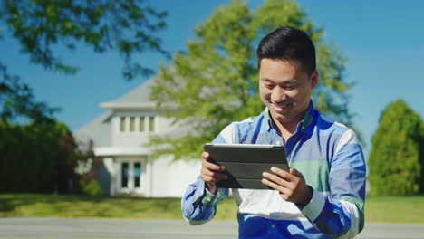 Happy-Man-Uses-a-Tablet-Near-Home
