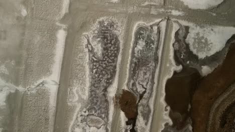 an intricate aerial drone capture showcasing the formation of salt particles on the terrain of salt valley