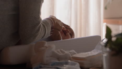 young mother kissing happy baby laughing enjoying loving mom nurturing toddler at home