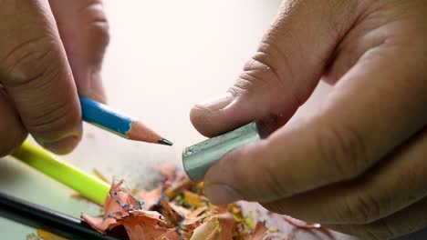 Footage-of-hands-slowly-sharpening-a-pencil-and-some-coloured-pencils-with-a-Wedge-Pencil-Sharpener