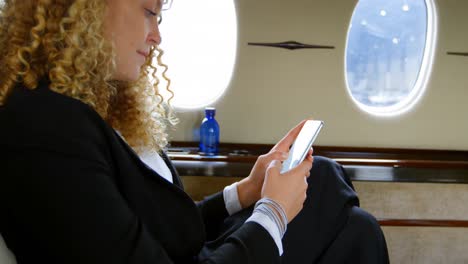 Businesswoman-using-mobile-phone-in-private-jet-4k