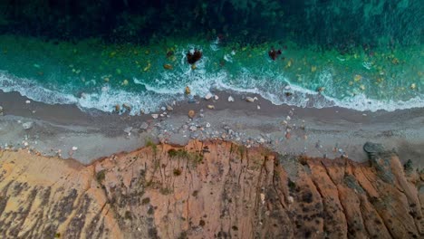 aerial view of the rocky shoreline of nerja, moving sideways slowly