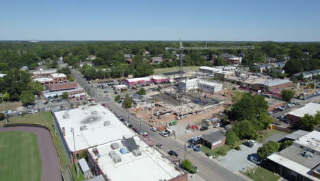 Drone-of-a-crane-over-construction-site,-new-building,-tall