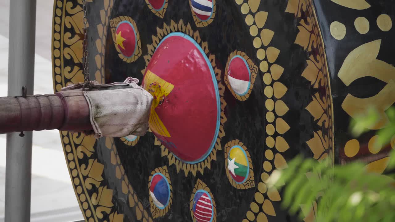 Big Swinging Mallet Hits Big Gong in Slow Motion at Buddhist Temple.
