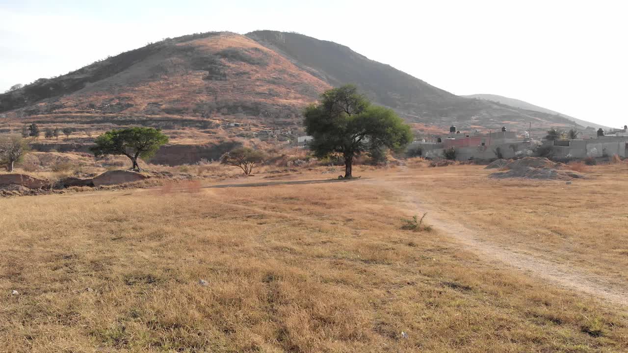 4k Drone flying over grass field, scenic hill region in Alta California, Mexico