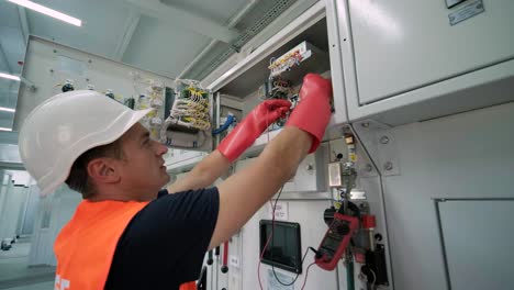 electrical engineers inspect the electrical systems at the equipment control cabinet