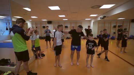 slow motion  video of a young boxer. kid  children training for boxing game. boxer trainer with children.