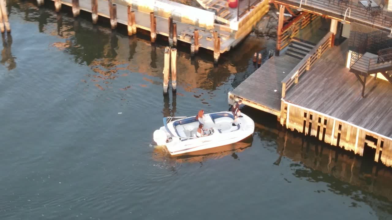 Tourists Arriving in Dock Riding White Speedboat - aerial shot
