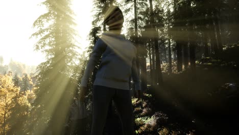 young woman standing alone outdoor with wild forest mountains