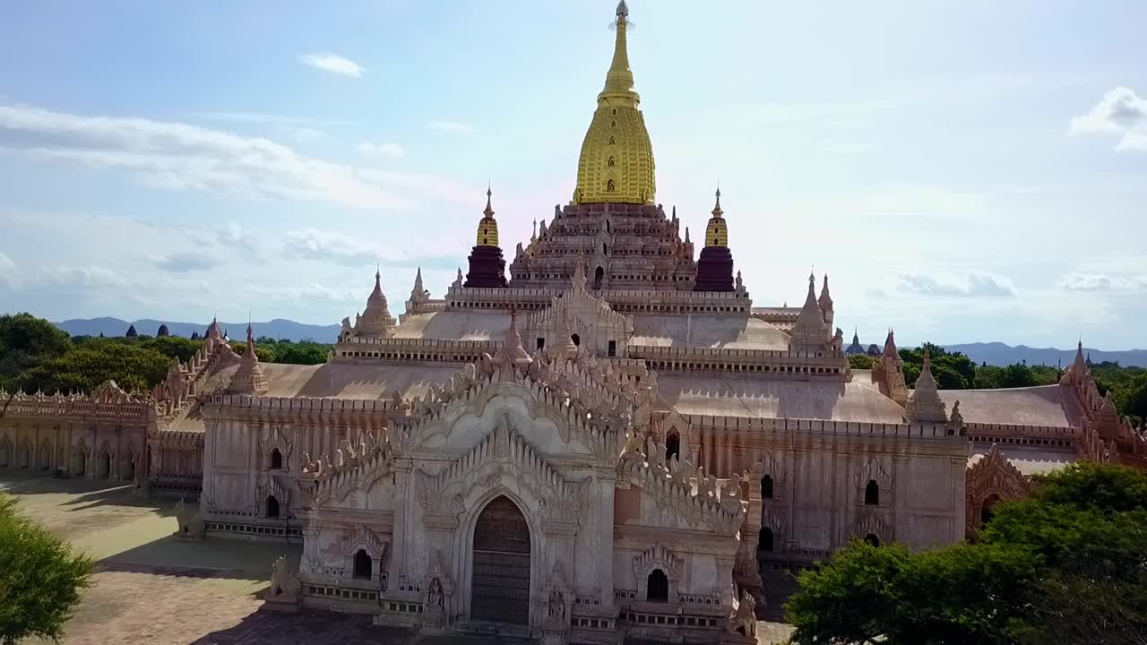 A captivating dolly-in establishing shot of the White Temple in Myanmar, highlighting its striking golden Sertok. Perfect for showcasing the temple's architectural grandeur and spiritual significance.