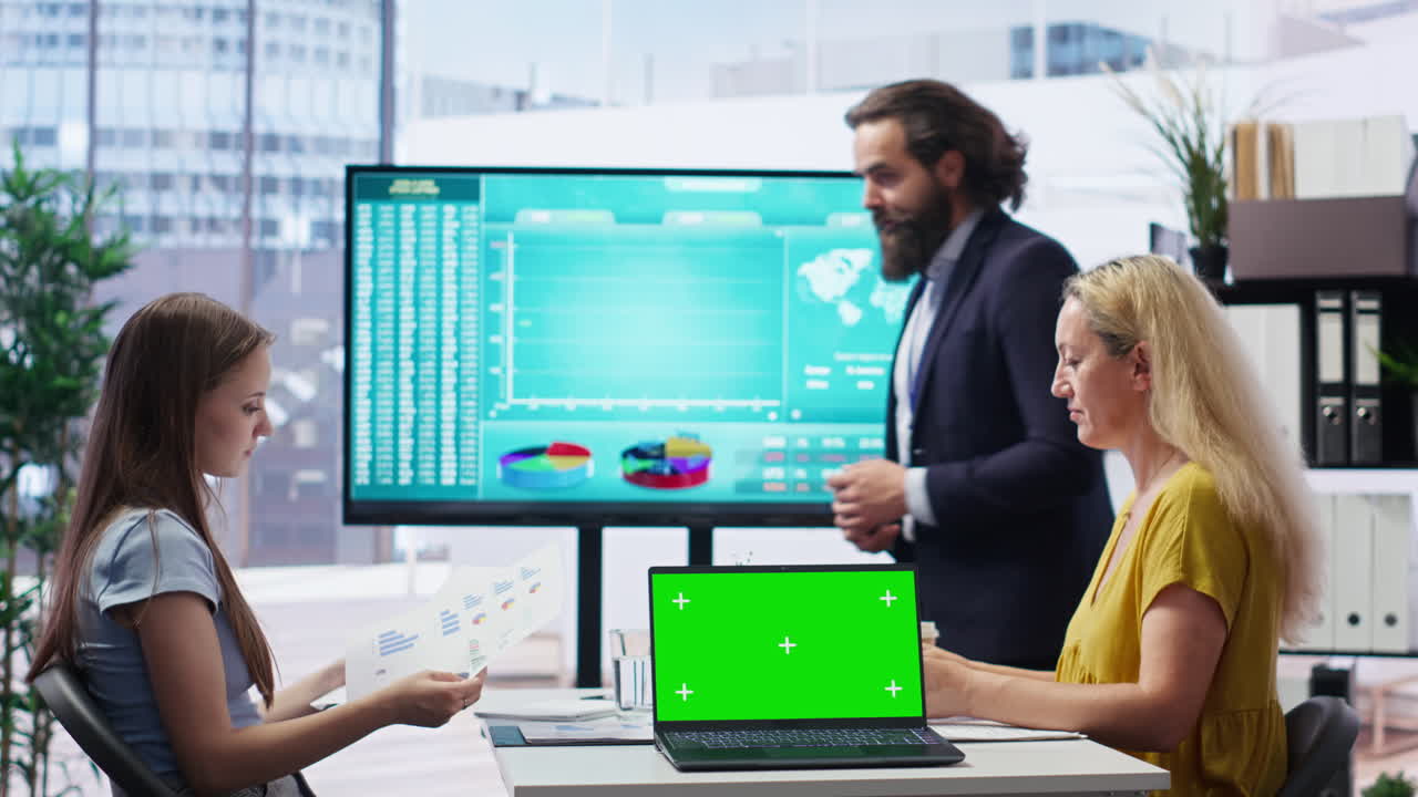 Broker showing stock exchange charts on chroma key laptop