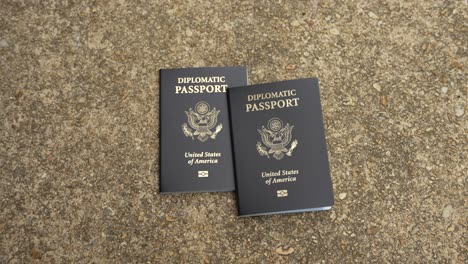 two isolated american diplomatic passports on cement, no person