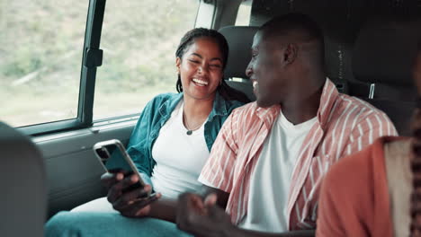 friends in a van looking at a phone