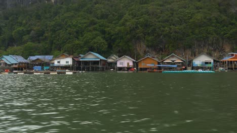 colorful houses of a muslim fishing village on koh panyee island, thailand, by the water